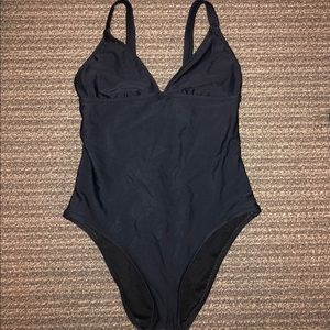 Open back, black one piece swimsuit.